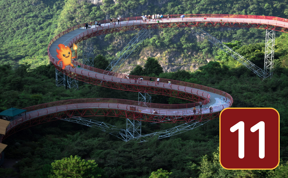 Very long serpentine steel walking bridge over heavily forested area with fire sprite.